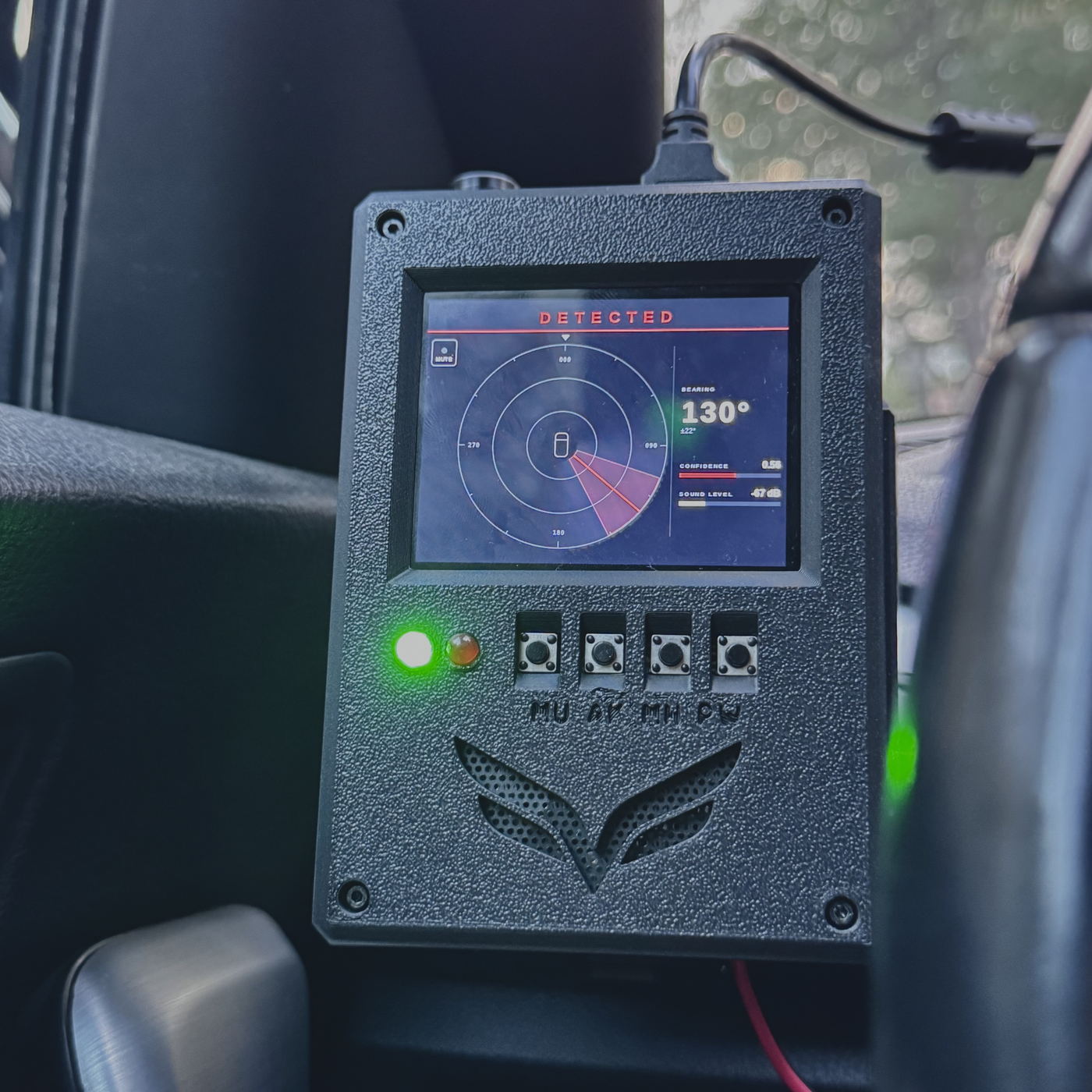 The GW-VNR1 driver-facing display mounted inside a vehicle, showing DETECTED, a bearing of 130 degrees with a confidence bar, and a highlighted sector on a compass rose.